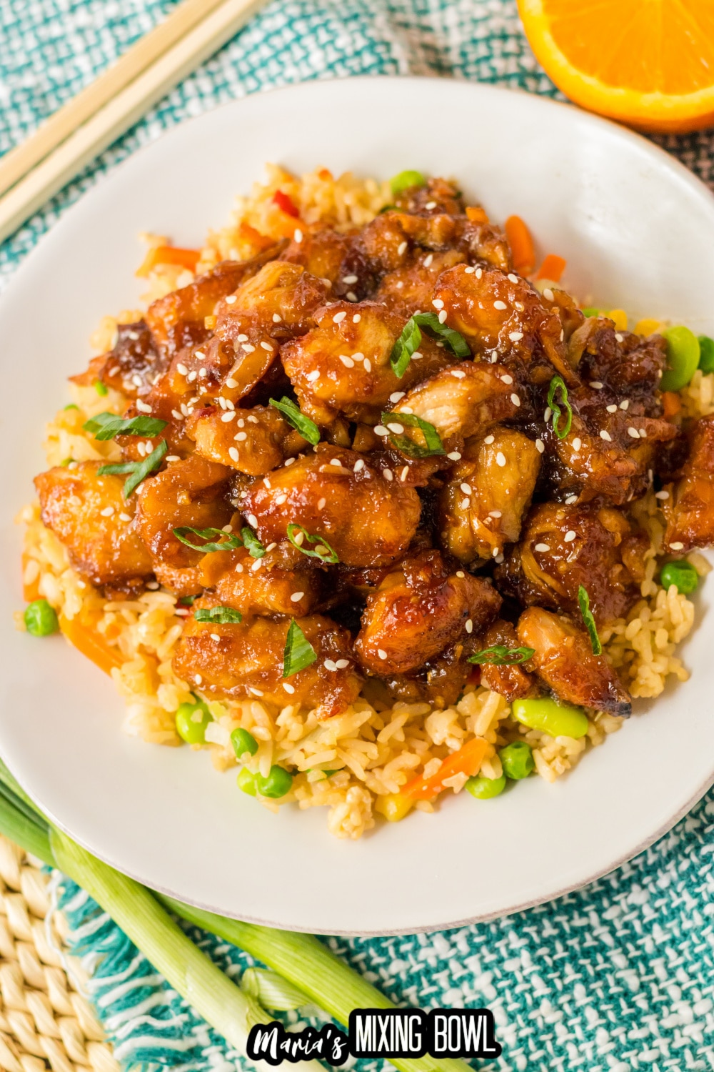 plate of slow cooker orange chicken on a bed of rice