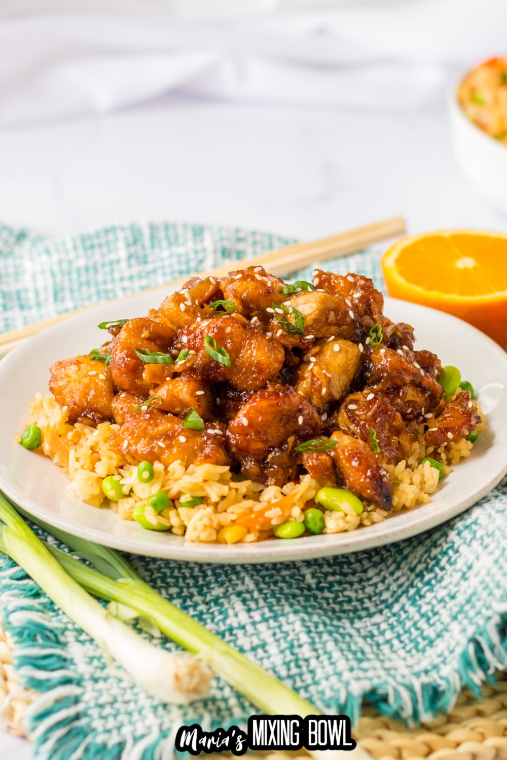 plate of slow cooker orange chicken on a bed of rice