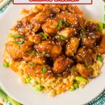 plate of slow cooker orange chicken on a bed of rice