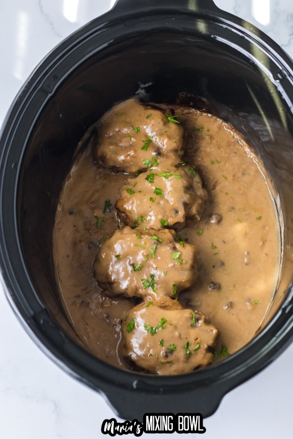 cooked smothered hamburgers in a slow cooker