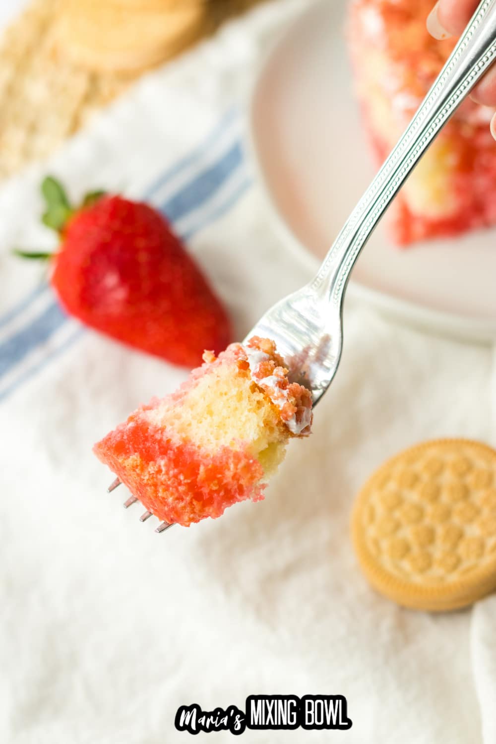 bite of cake on a stainless steel fork held in the air