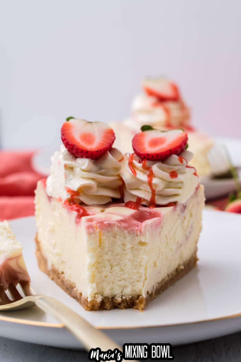 slice of strawberry swirl cheesecake on a white plate