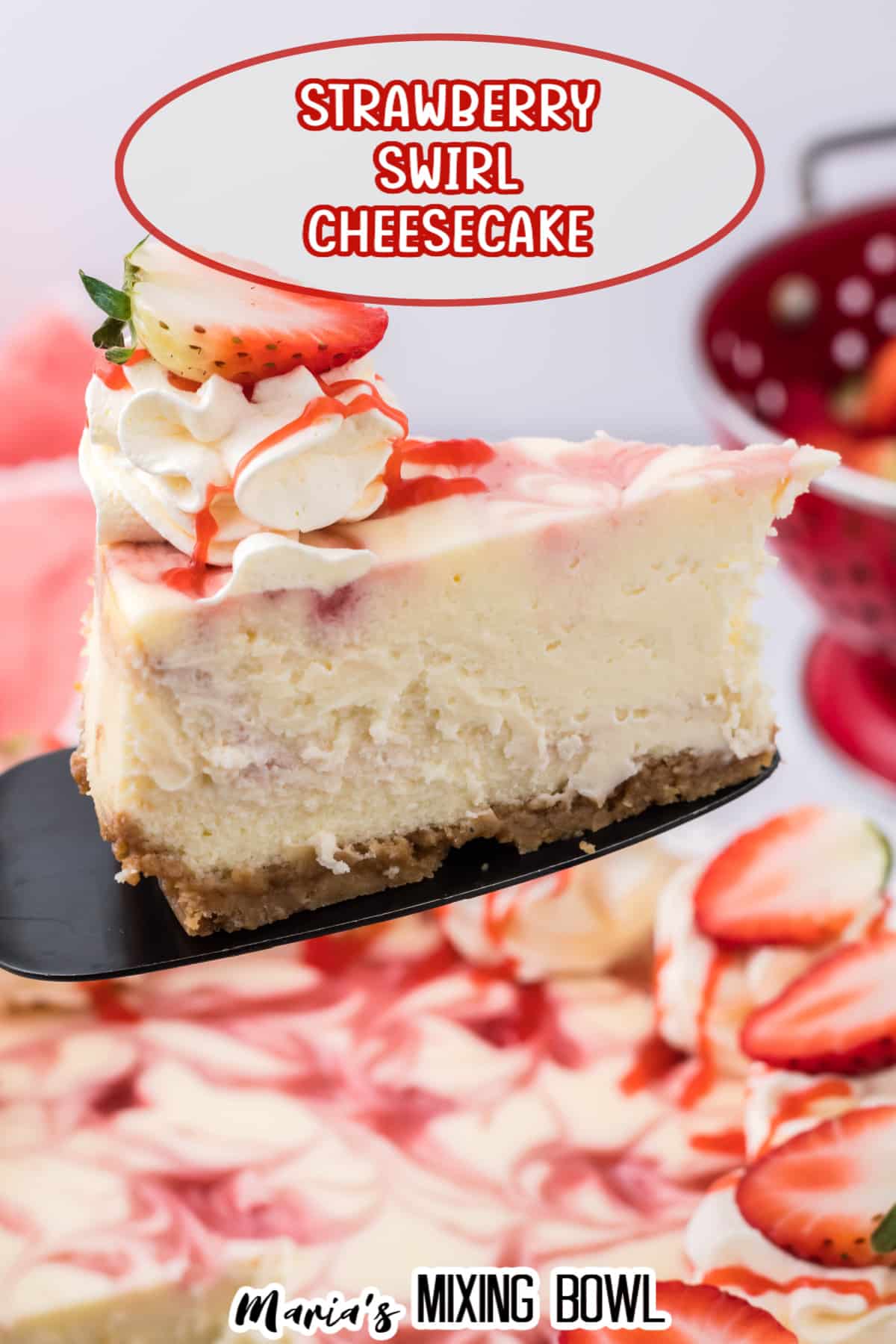 slice of strawberry swirl cheesecake on a cake cutter held in the air
