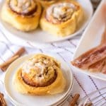 bacon cinnamon roll on three stacked small plate