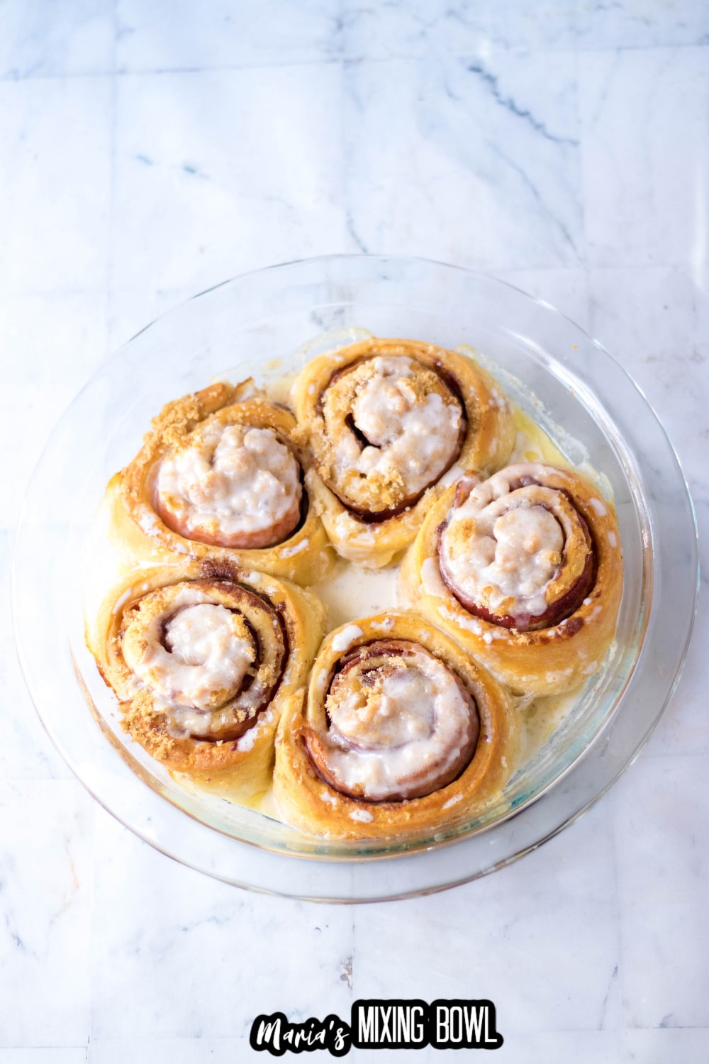 baked cinnamon rolls in a glass pie plate