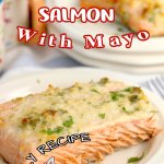 birds eye image of a baked salmon filet on a white plate that is garnished with fresh parsley