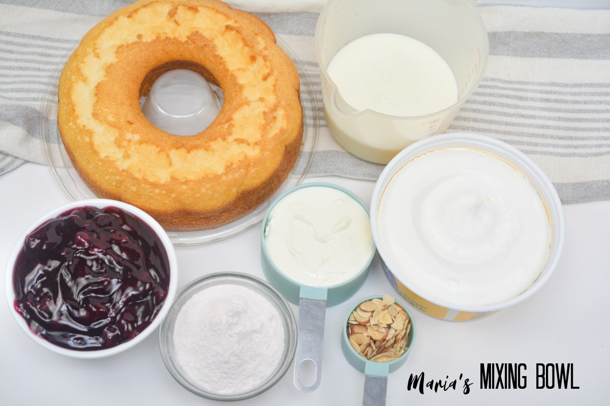 angel food cake, whipped topping, blueberry pie filling, milk, vanilla instant pudding, sour cream, sliced almonds