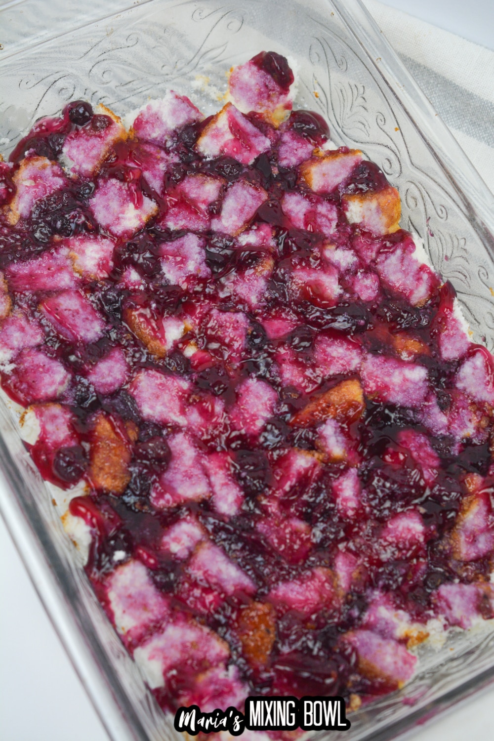 cake pieces in a baking sheet topped with blueberry pie filling