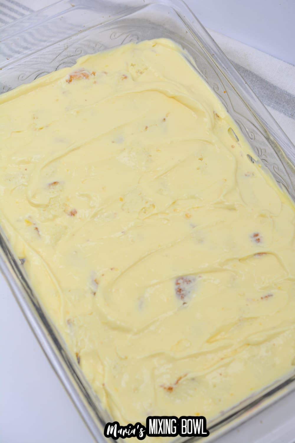 vanilla pudding spread on top of cake pieces and blueberry pie filling