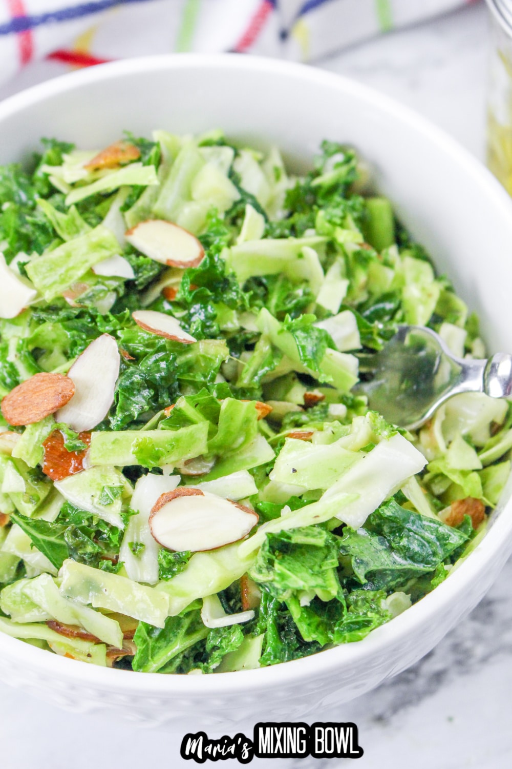 white bowl filled with kale salad.