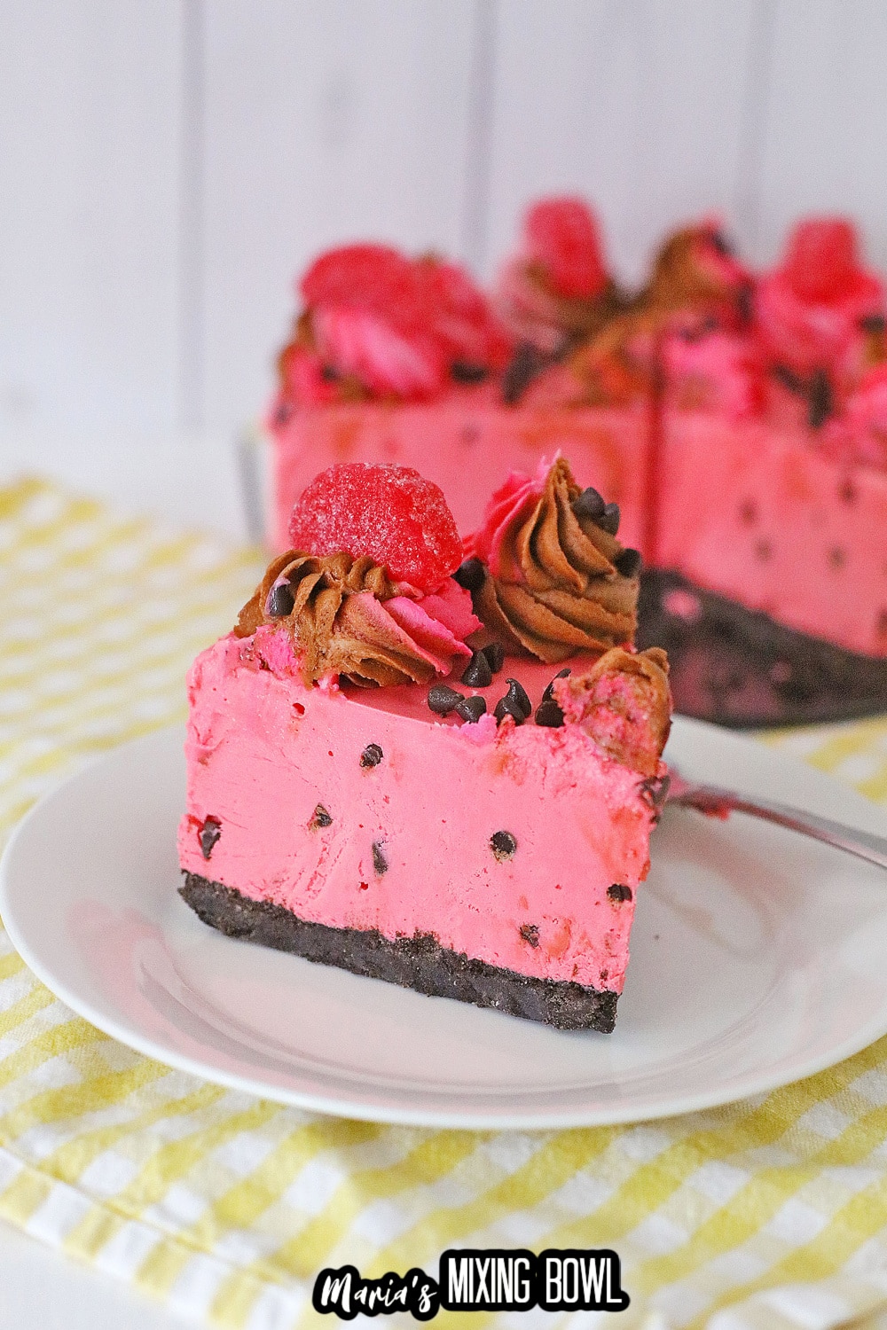 slice of chocolate chip cherry cheesecake on a white plate