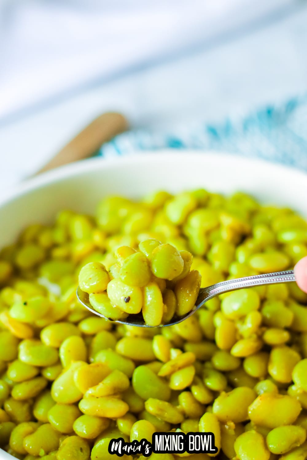 spoonful of lima beans held in the air
