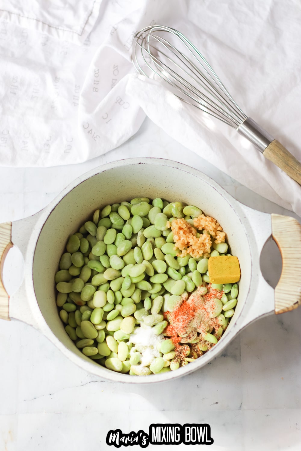 lima beans, garlic, and seasonings in a white saucepan