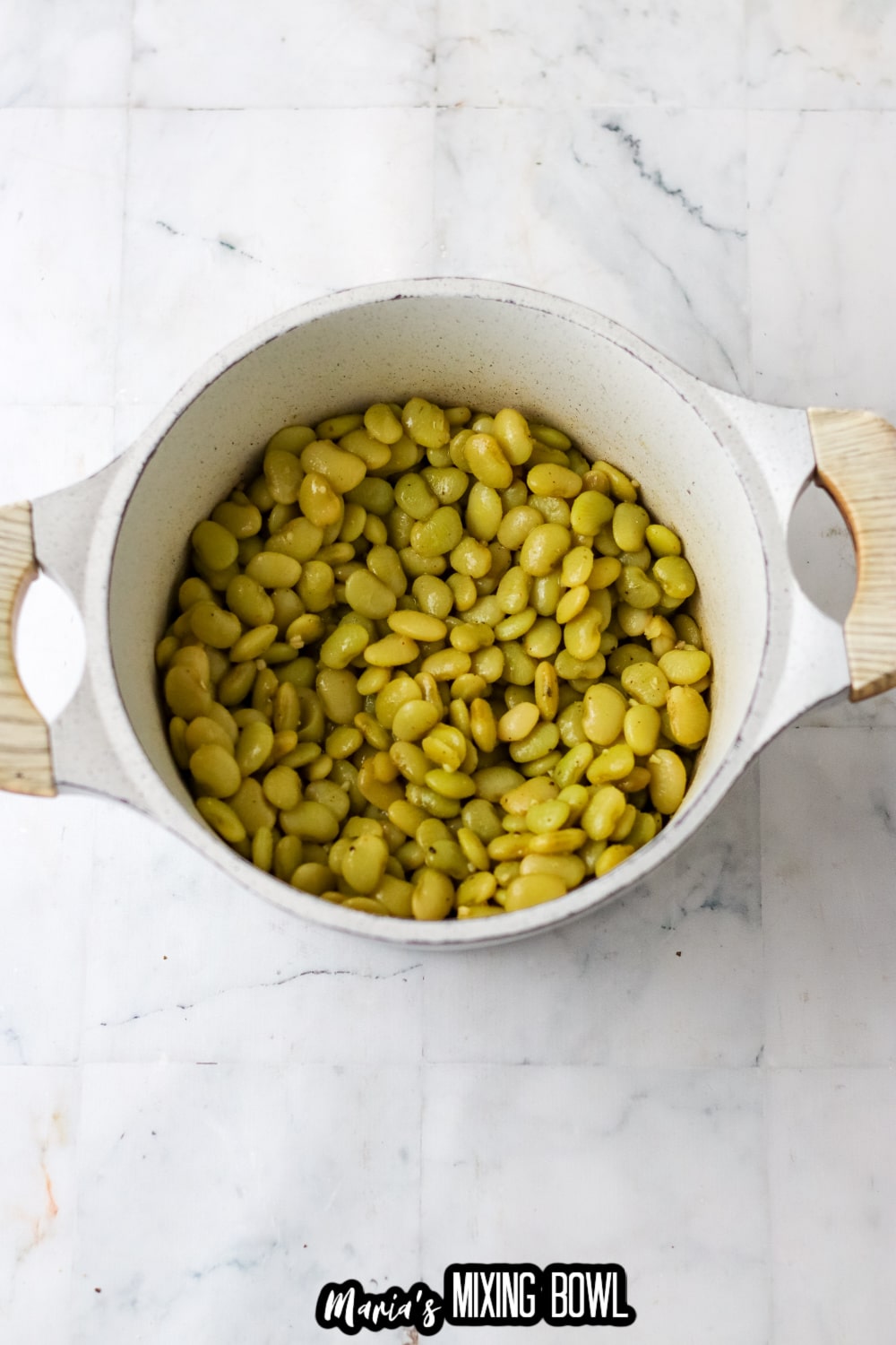 white sauce pan filled with lima beans