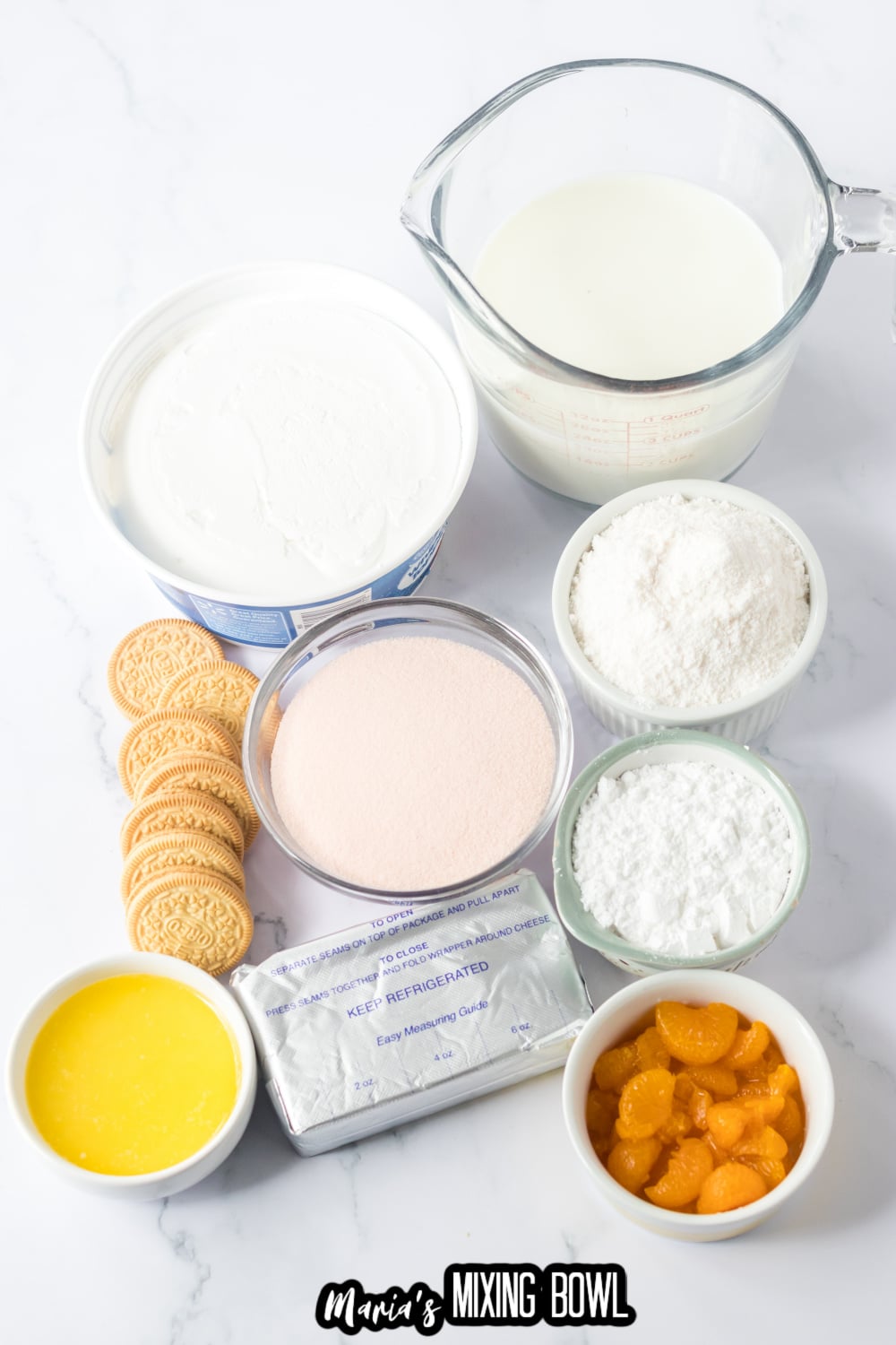 cool whip, milk, gelatin, powdered sugar, oranges, cream cheese, oreos, and melted butter on an marble background