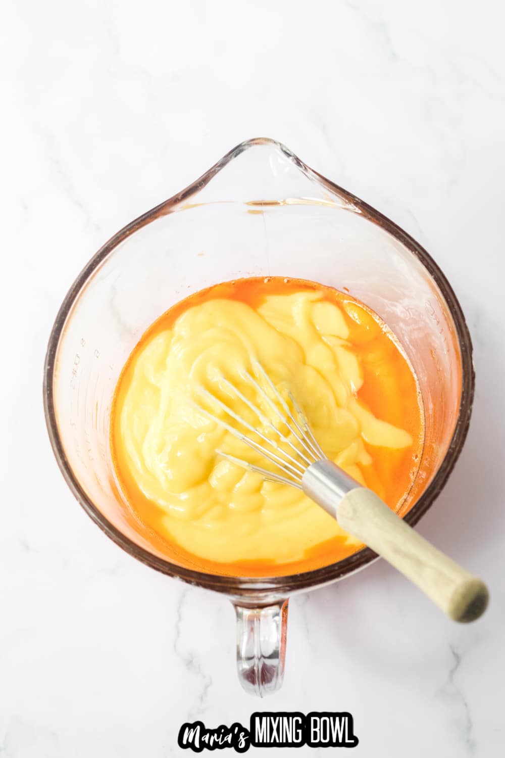 vanilla pudding and orange gelatin being mixed together