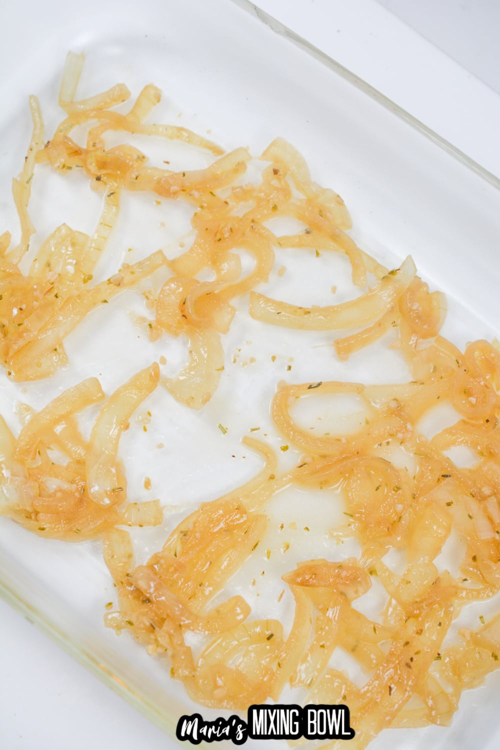 cooked onions in a glass baking dish