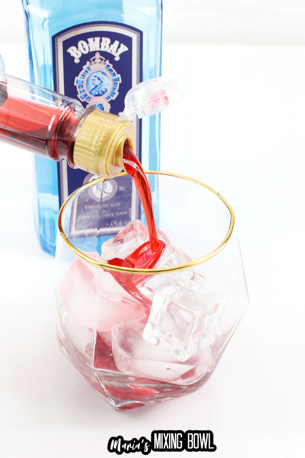 raspberry syrup being poured into a glass