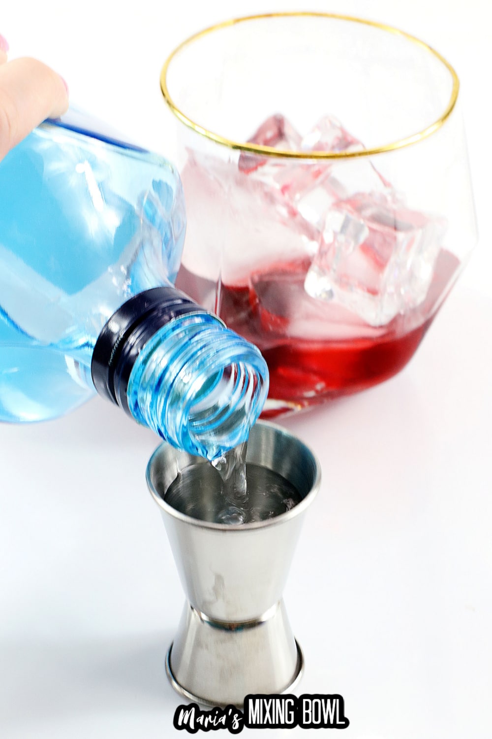 gin being measured in a jigger