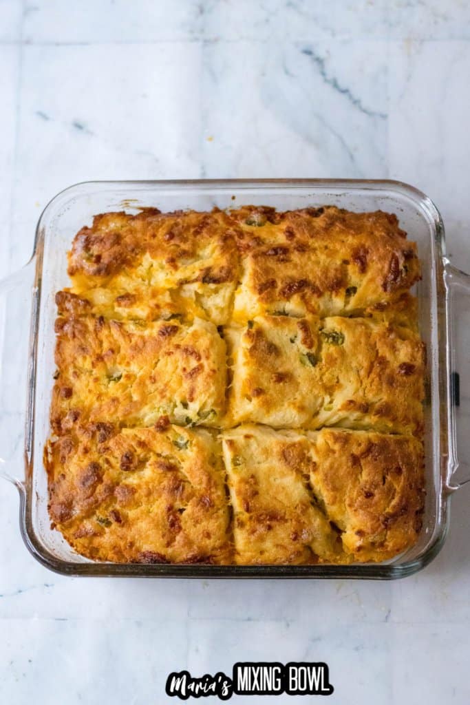 baked jalapeno cheddar biscuits in a glass baking dish