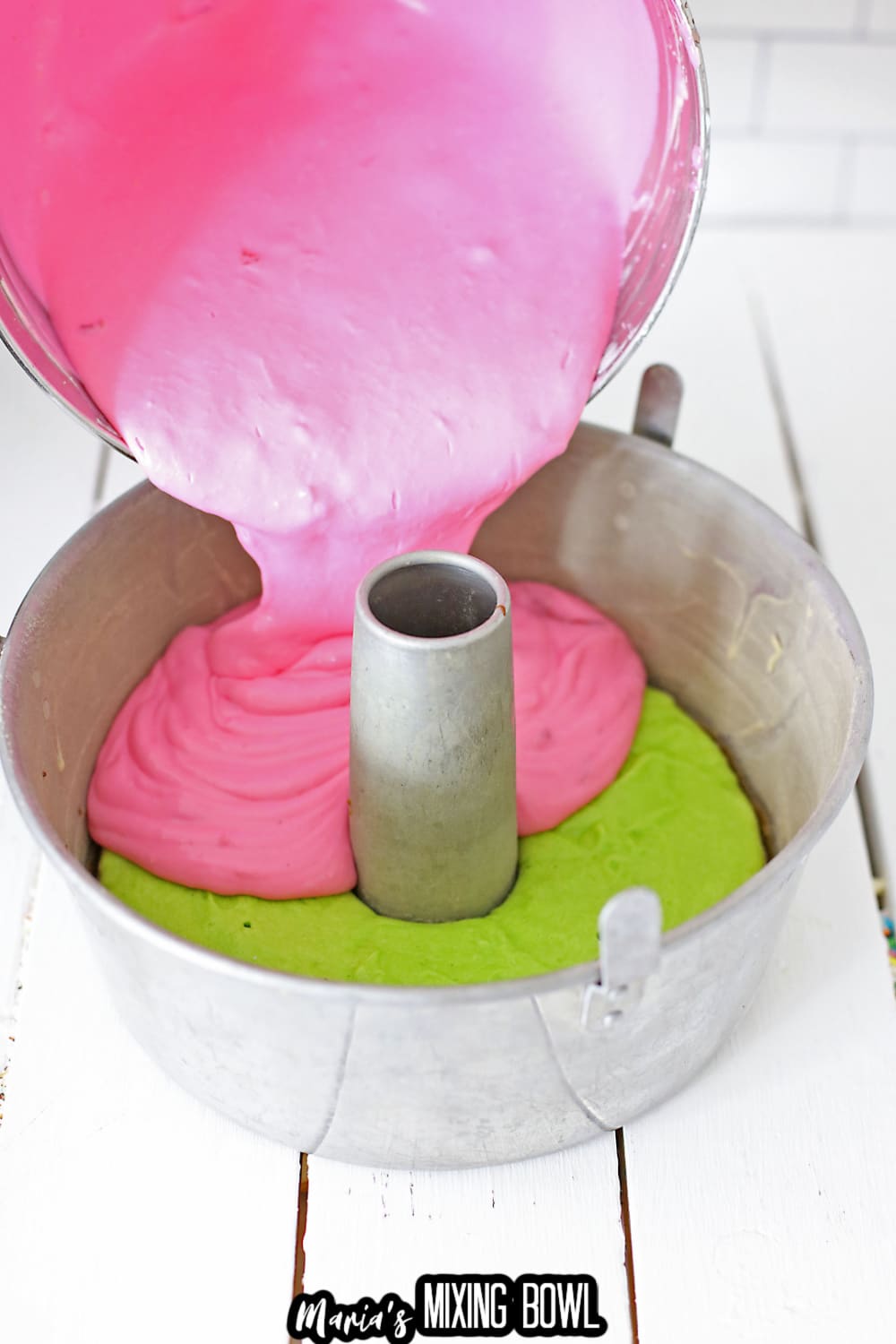 cake batter being poured into a bundt cake pan