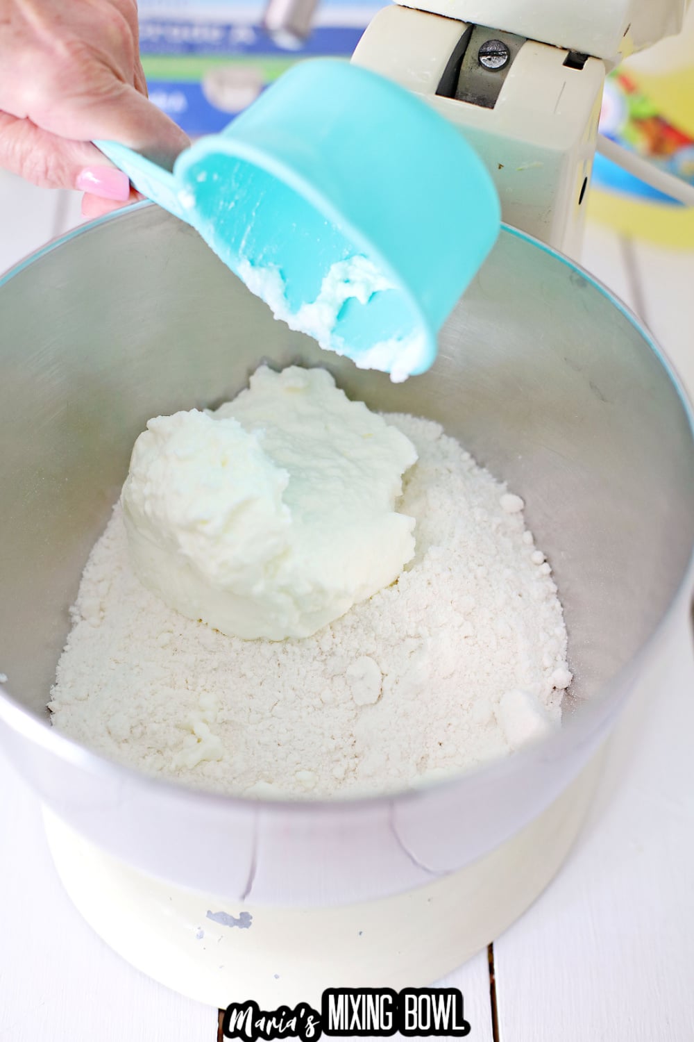 cream cheese and powdered in a bowl to a stand mixer