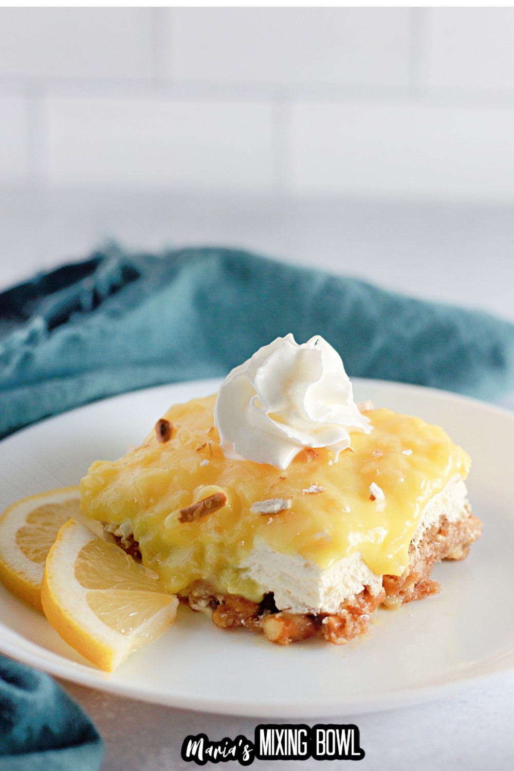 slice of pineapple pretzel salad on a white plate with a sliver fork
