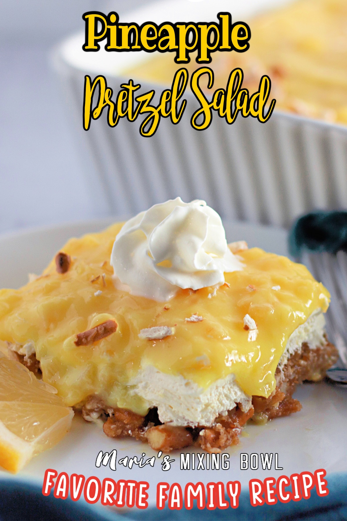 slice of pineapple pretzel salad on a white plate with a sliver fork.