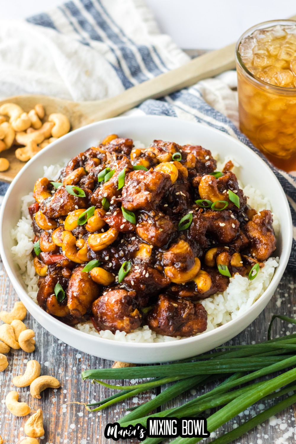 a white bowl filled with slow cooker cashew chicken and white rice