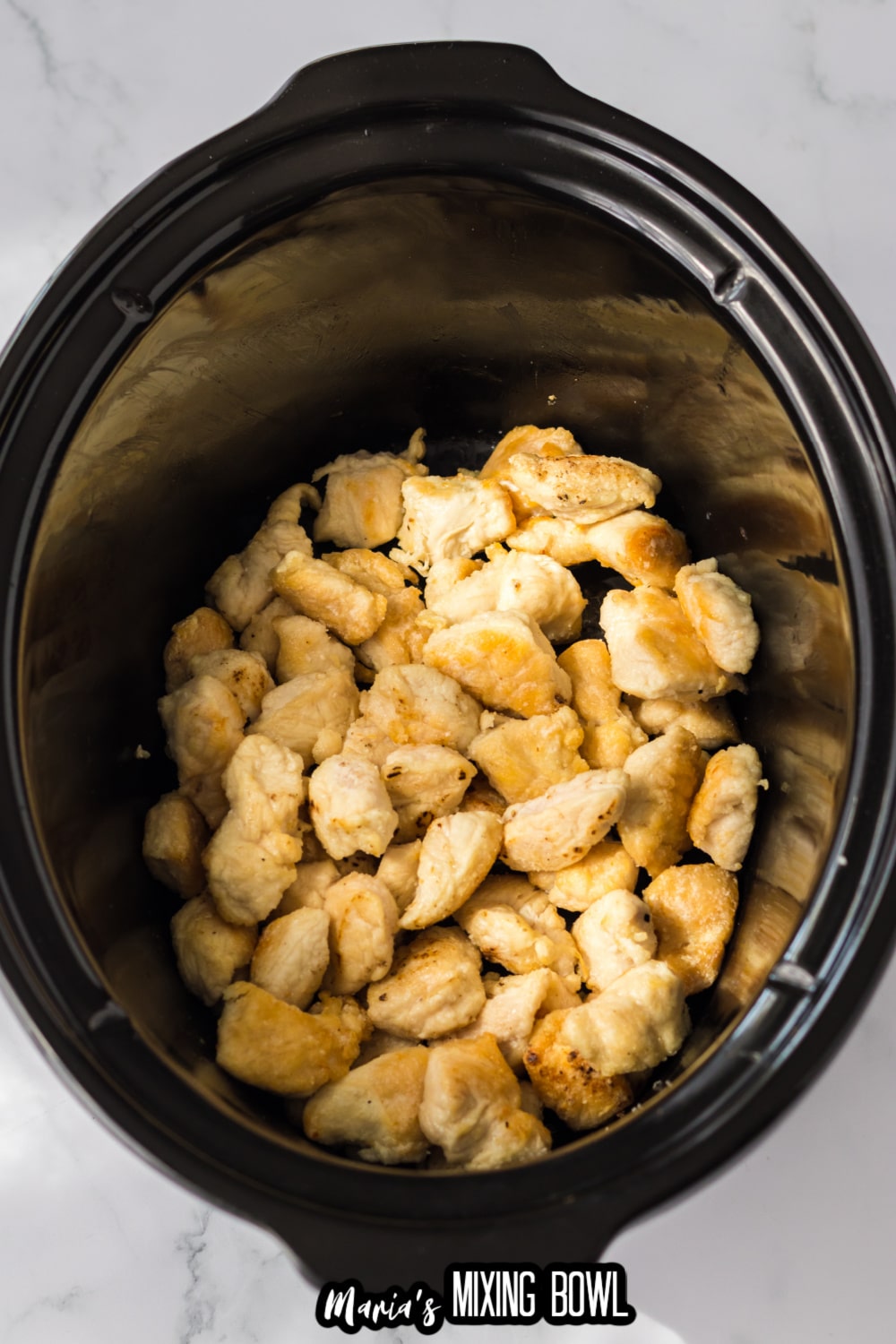 browned chicken in a slow cooker