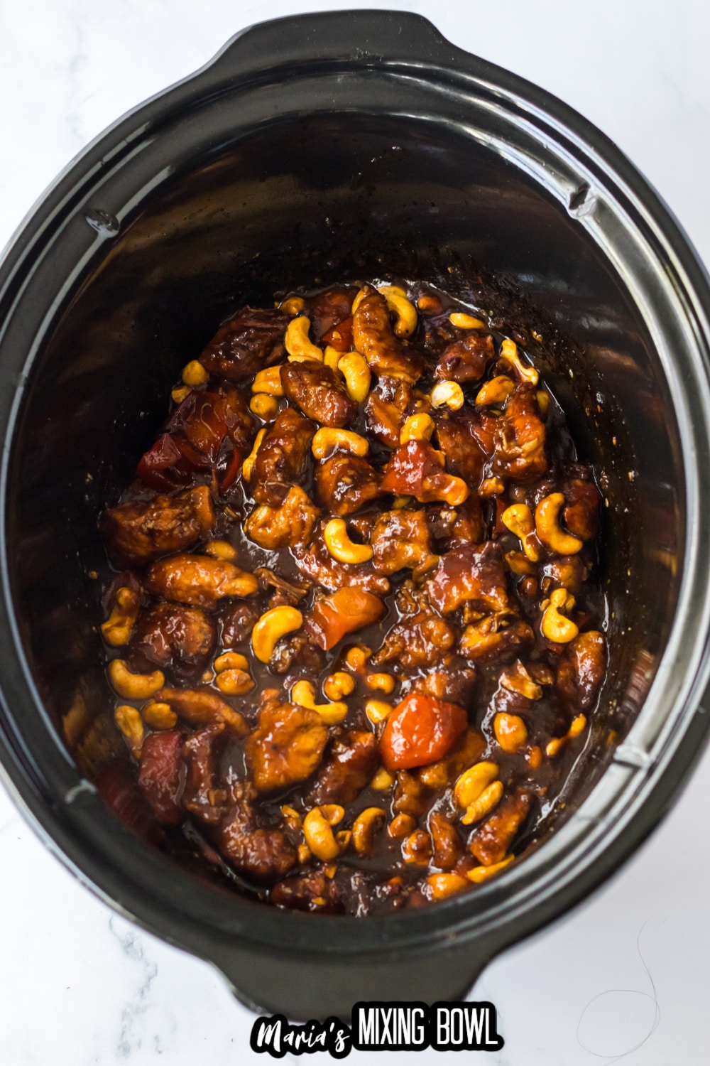 cooked cashew chicken in a slow cooker