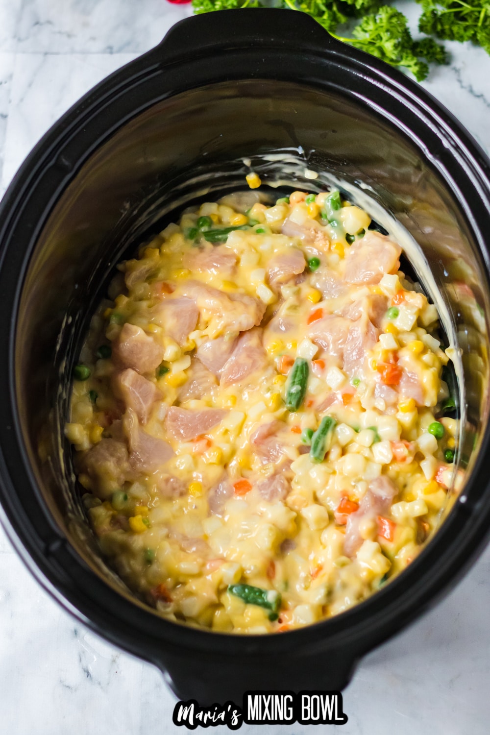 chicken and mixed vegetables in a slow cooker