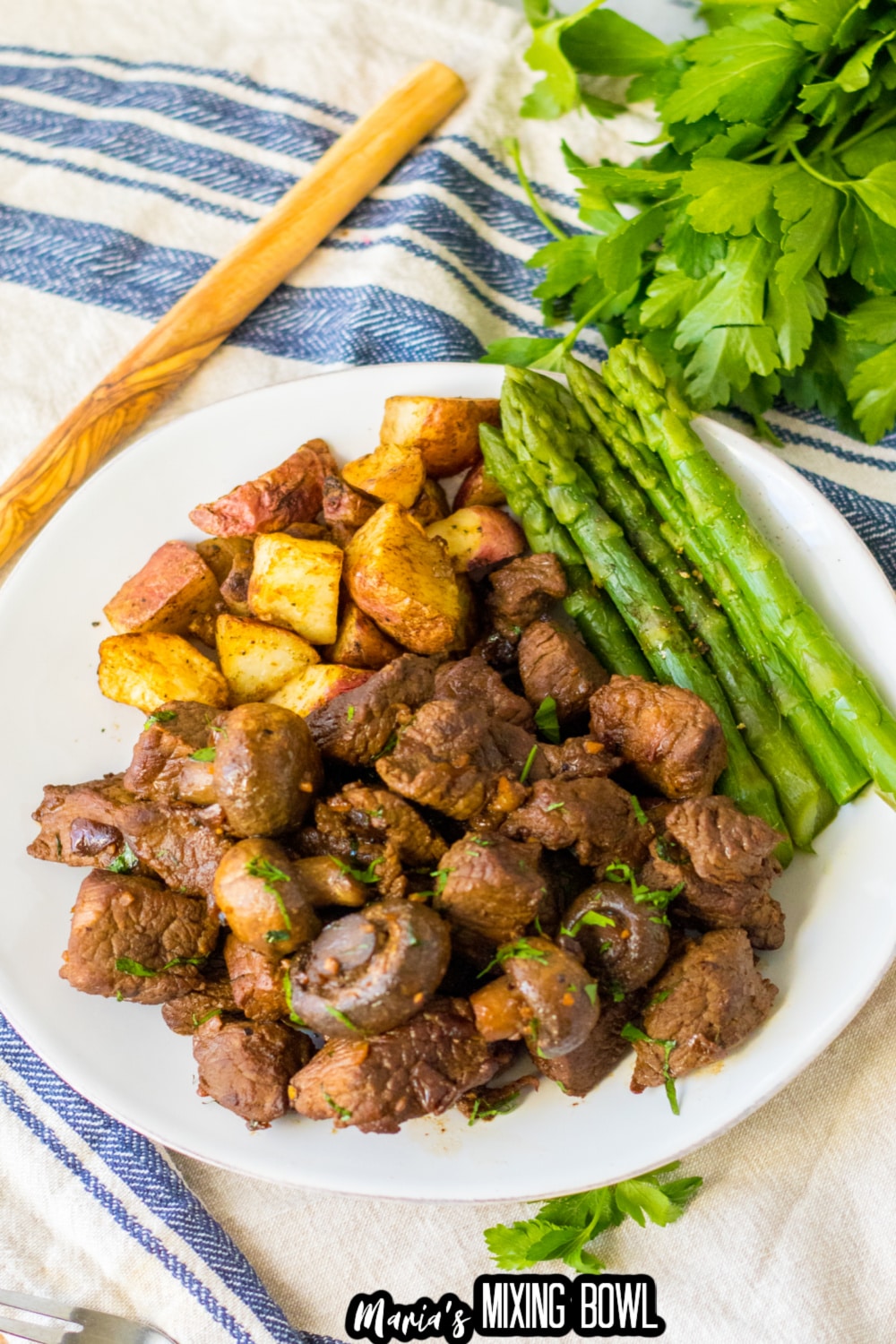 white plate filled with mushroom steak bites on a white plate