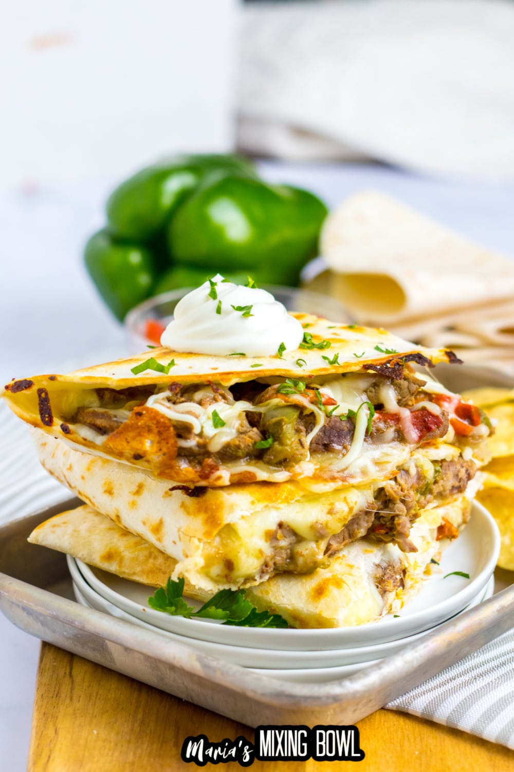 three slow cooker quesadillas stacked on a white plate