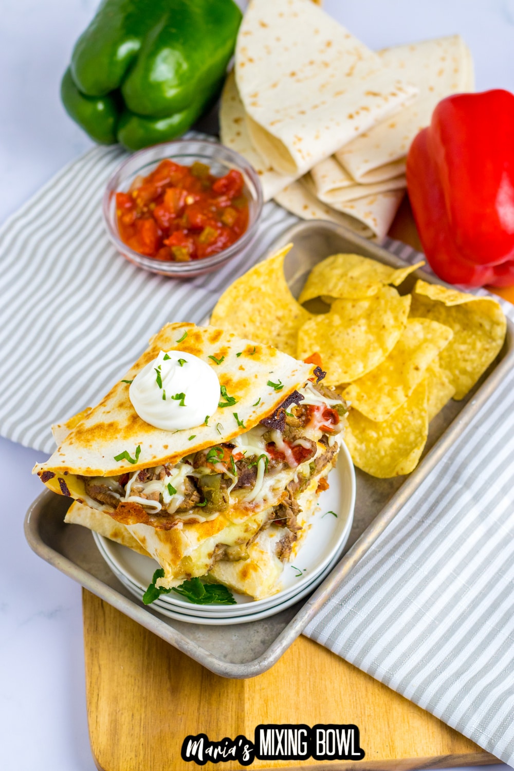 three slow cooker quesadillas on a metal serving