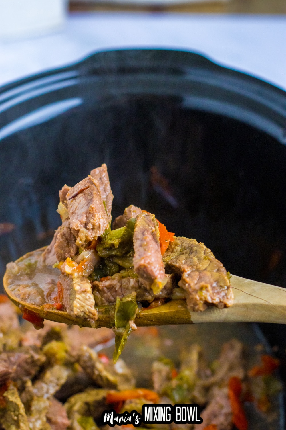 beef, peppers and onions in a slow cooker