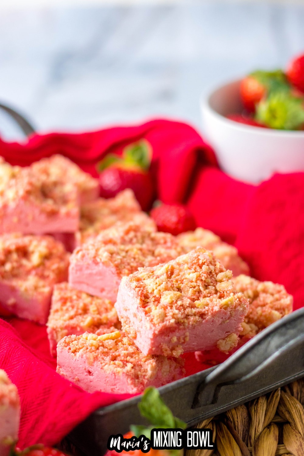 stack of strawberry fudge on a red napkin lined baking tray