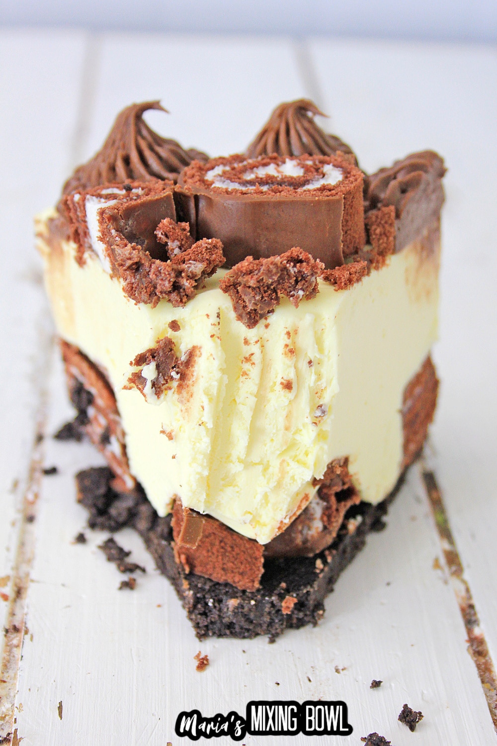 close up of a slice of swiss roll cake cheesecake with a bite missing