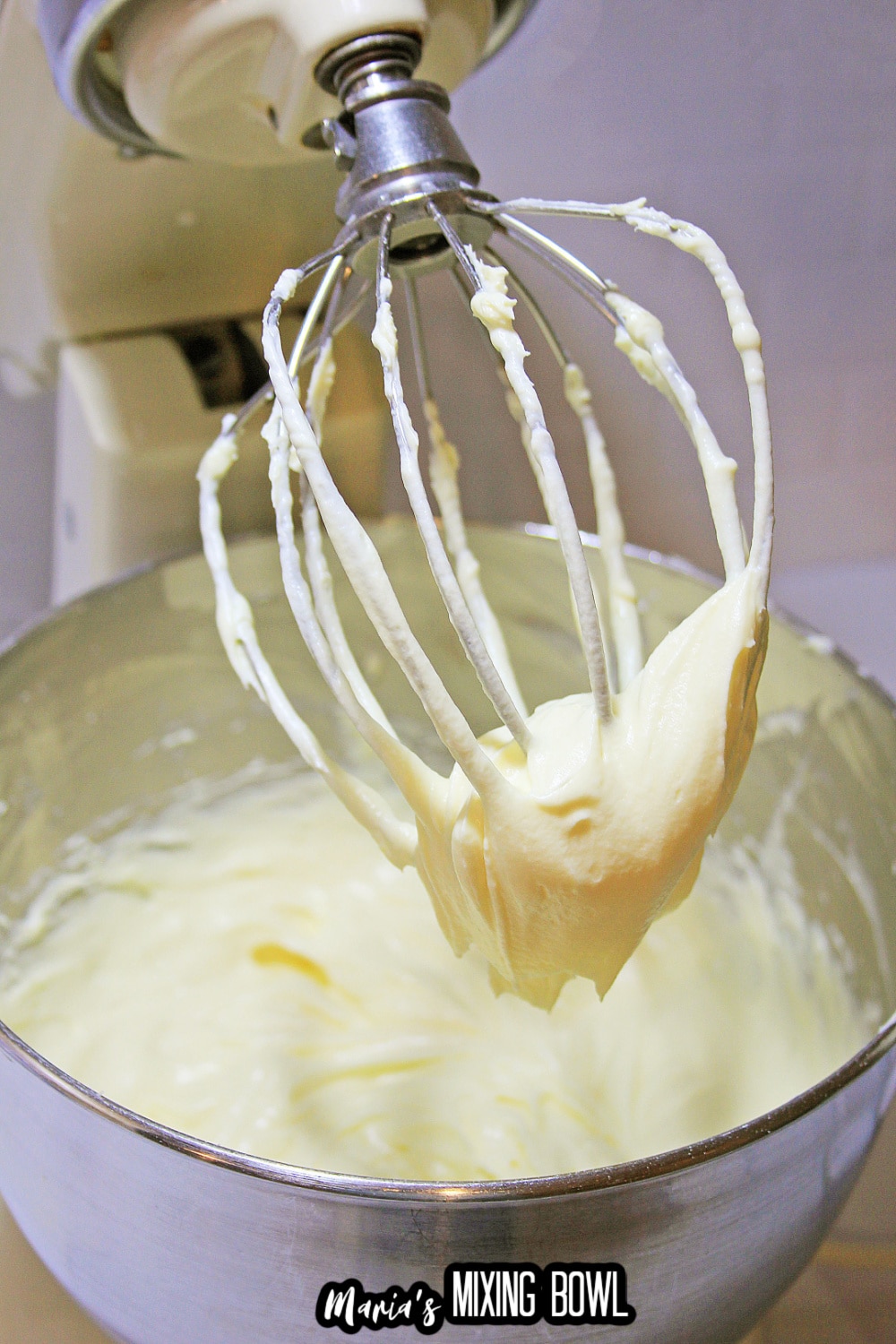 cheesecake batter in stand mixer with the whisk attachment