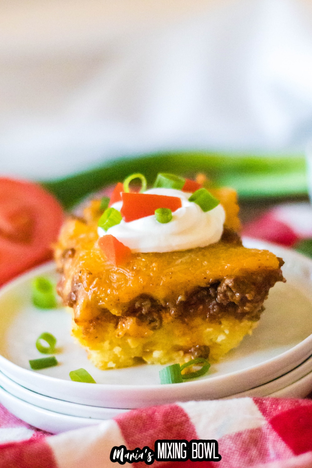 slice of tamale casserole on a stack of three plates