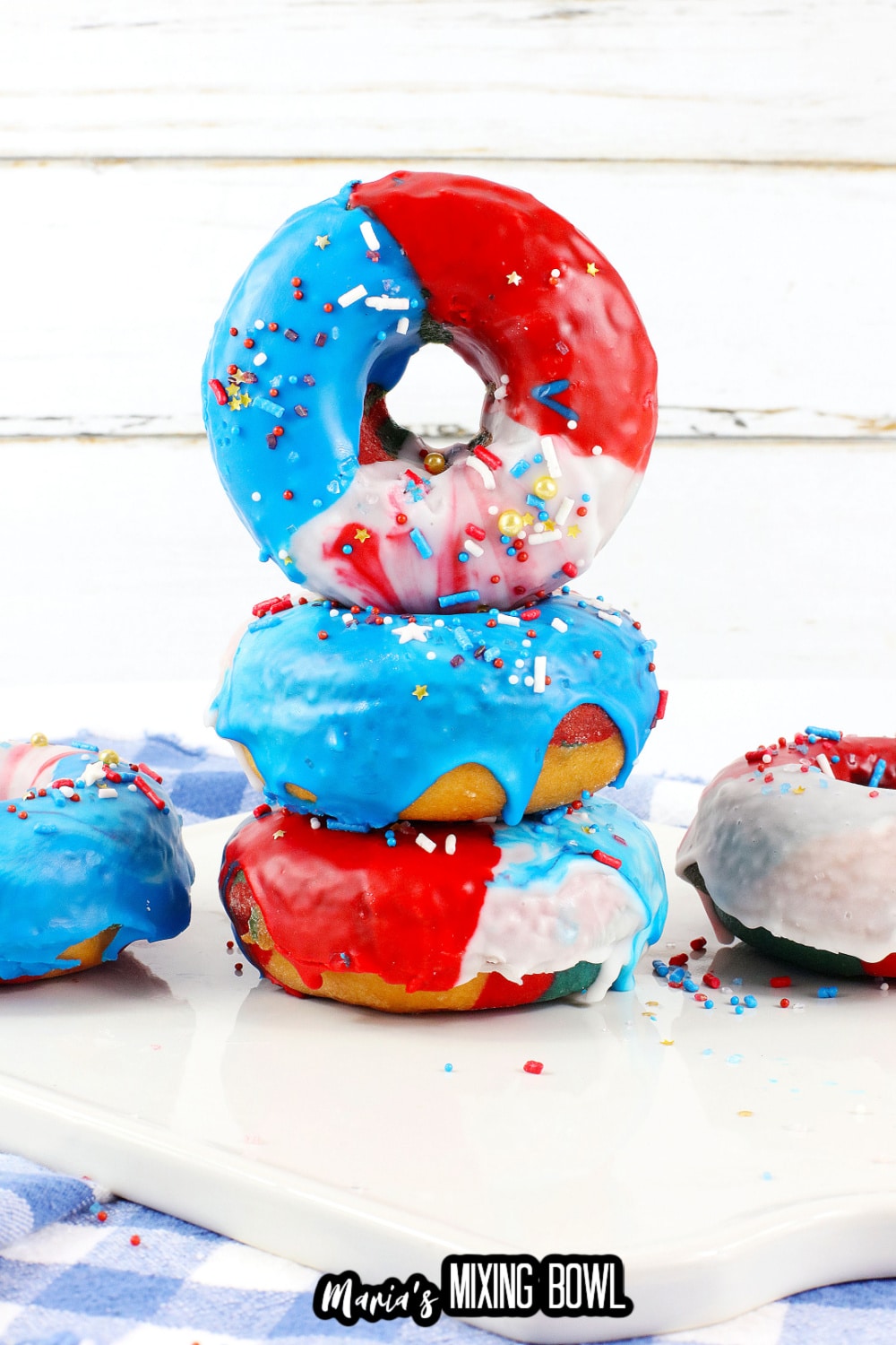 three donuts stacked on top of each other a white cutting board