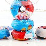 three donuts stacked on top of each other a white cutting board