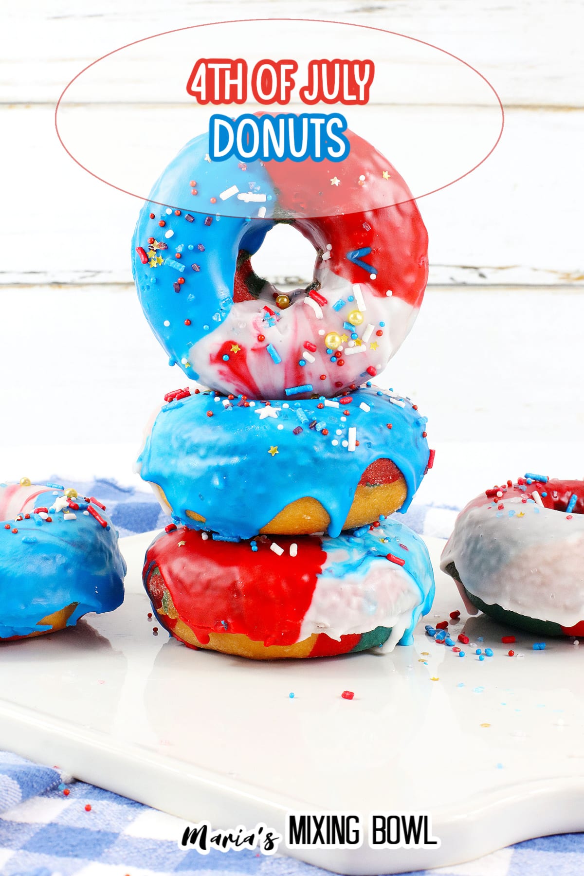 three donuts stacked on top of each other a white cutting board