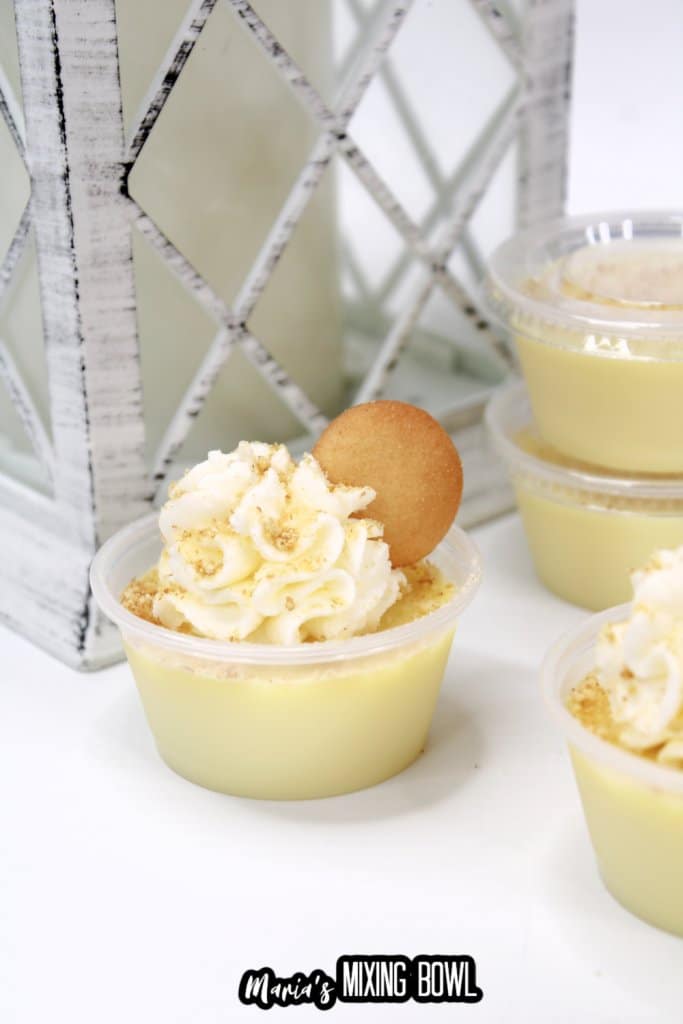 banana cream pie shots on a white background with a wooden lantern in the background