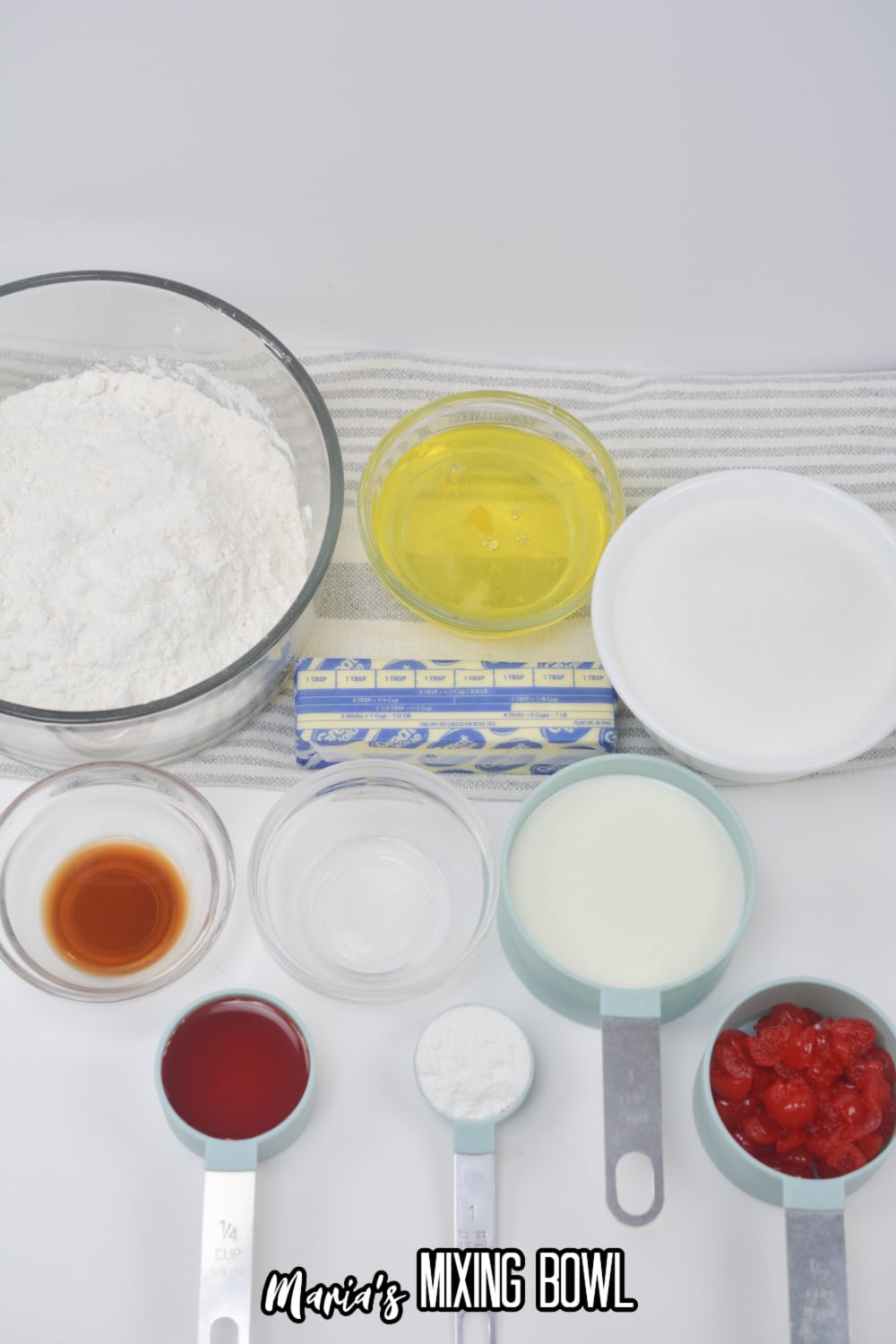 cake mix, oil, cherries, butter, vanilla, and cherry juice on a white background