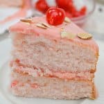 slice of cherry almond cake on a white plate