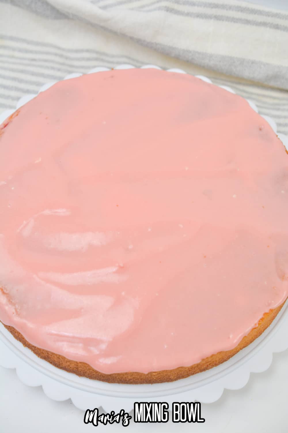 bottom layer of the cake being frosted
