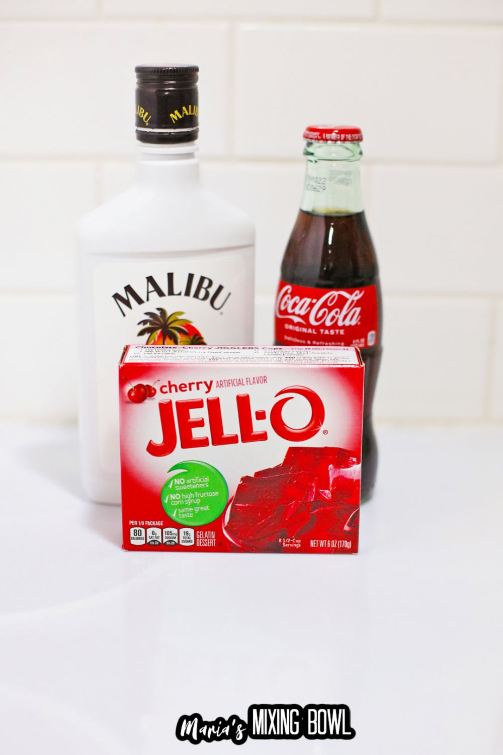 box of cherry jello, bottle of malibu rum, and bottle of coke