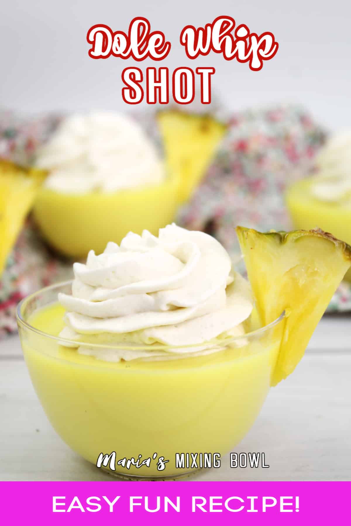 dole whip shot in a small glass bowl garnished with a slice of pineapple