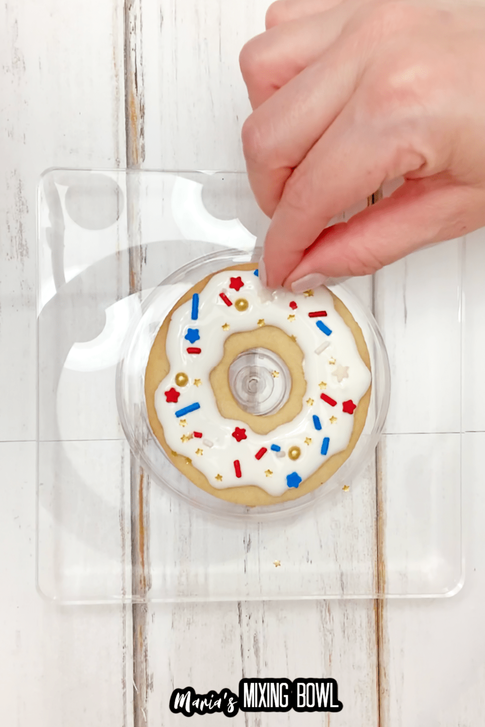 sprinkles being added to the top of a cookie